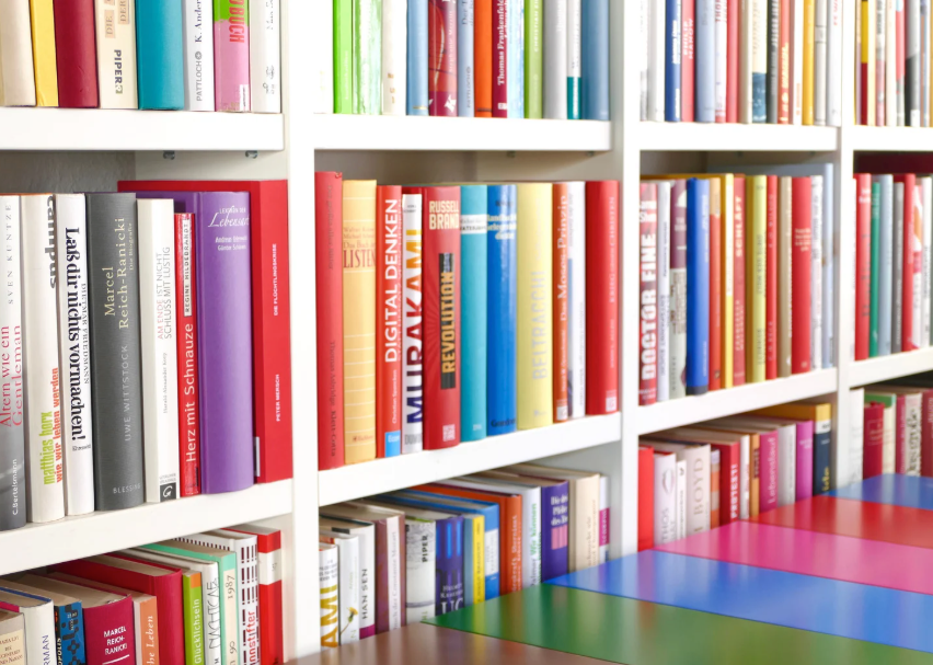 Colorful books on a white bookshelf

